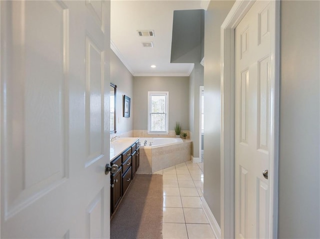 bathroom featuring tiled bath, crown molding, tile patterned floors, and vanity