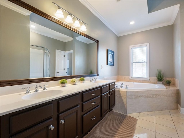 bathroom with tiled bath, ornamental molding, tile patterned floors, and vanity