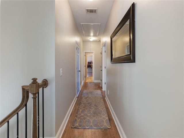 corridor with hardwood / wood-style floors