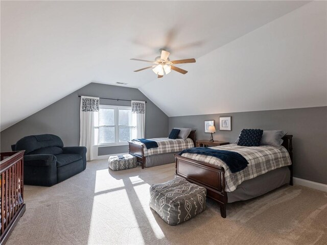 carpeted bedroom with ceiling fan and lofted ceiling