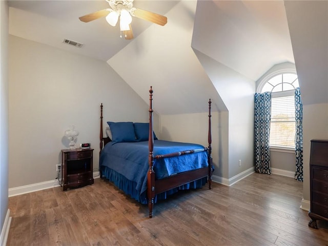 bedroom with ceiling fan, wood-type flooring, and lofted ceiling