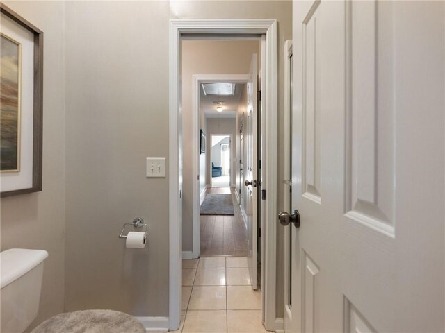 bathroom featuring toilet and tile patterned flooring