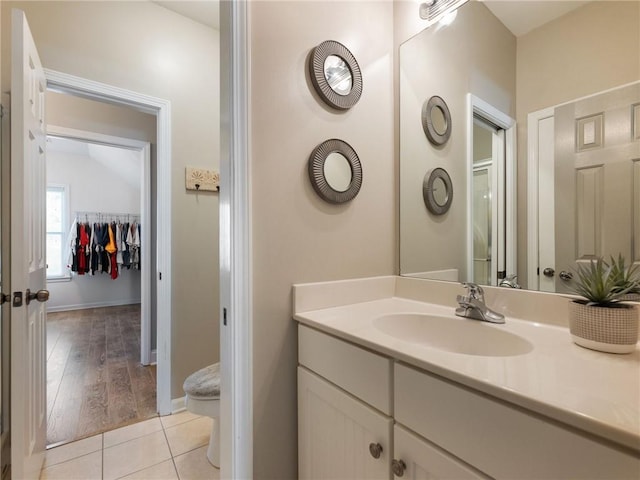 bathroom with toilet, tile patterned flooring, an enclosed shower, and vanity