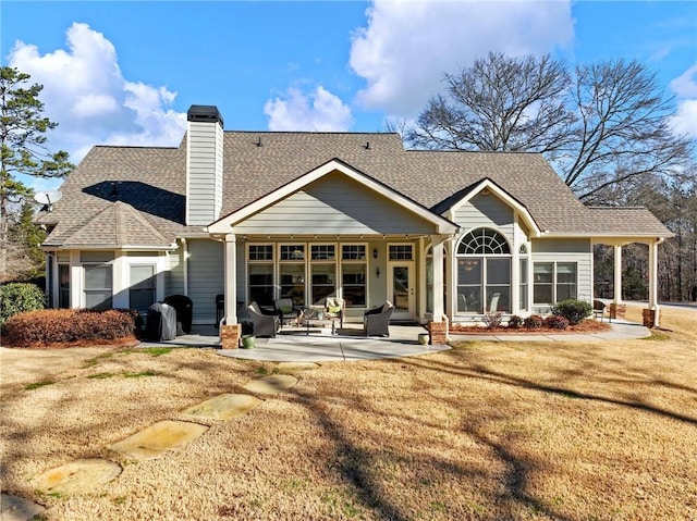 back of house with a yard and a patio