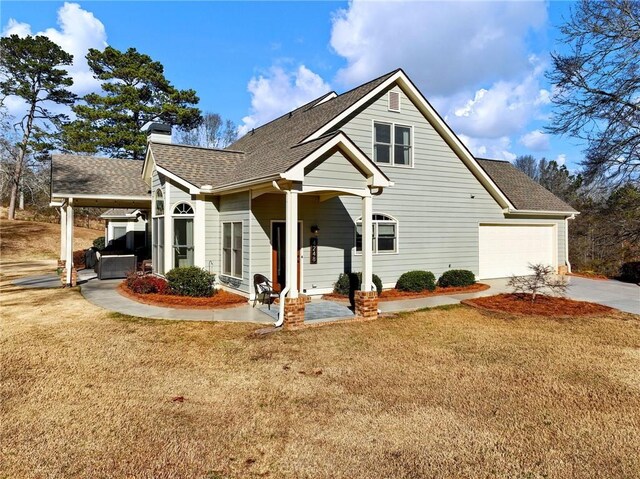 view of front of home with a garage and a front yard