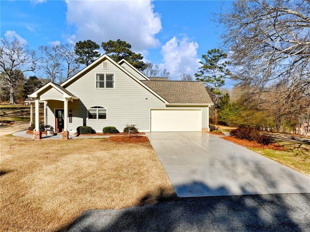 front facade with a garage and a front lawn