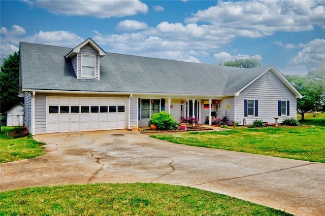 view of front of home with a garage and a front lawn