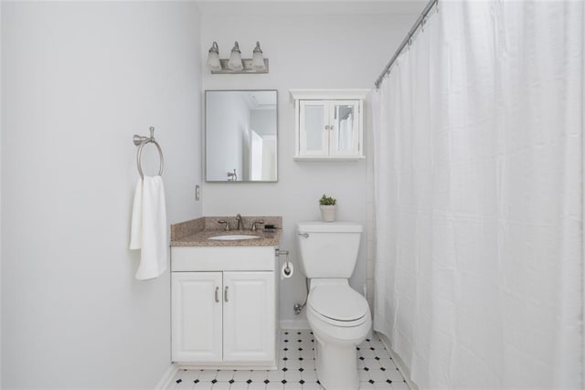 bathroom featuring tile floors, toilet, and oversized vanity