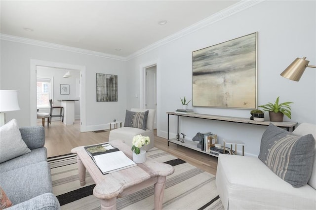 living room with light hardwood / wood-style floors and crown molding