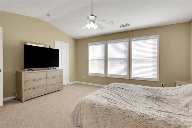 bedroom featuring visible vents, baseboards, light colored carpet, vaulted ceiling, and a ceiling fan