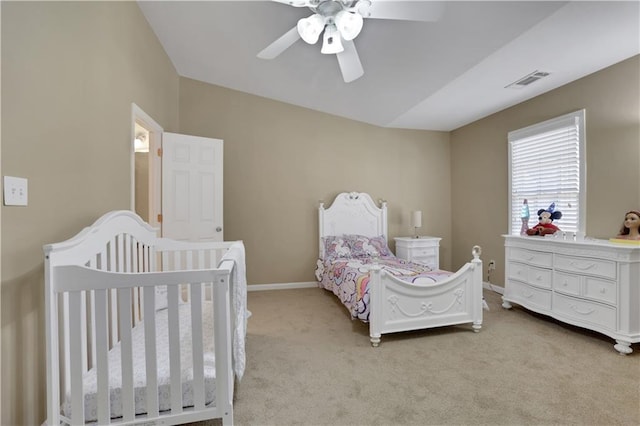 bedroom featuring ceiling fan, baseboards, visible vents, and light carpet