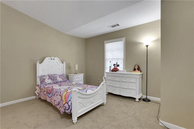 bedroom with visible vents, light colored carpet, and baseboards