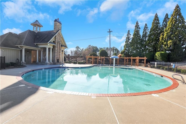 pool featuring a patio and fence