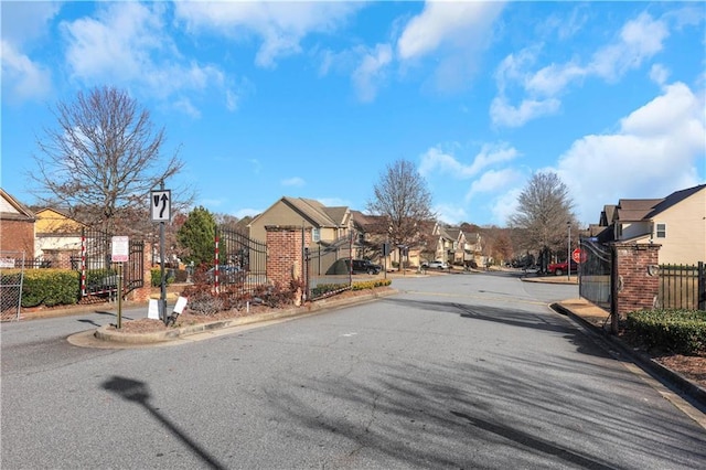 view of street featuring a residential view, curbs, and traffic signs