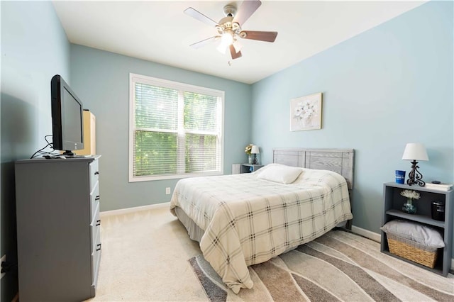 bedroom with baseboards, light colored carpet, and ceiling fan