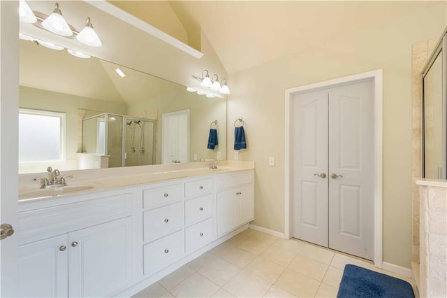 full bathroom featuring vaulted ceiling, a stall shower, double vanity, tile patterned flooring, and baseboards