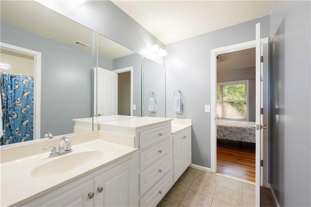 bathroom with tile patterned floors, vanity, connected bathroom, and baseboards