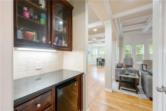 indoor dry bar with coffered ceiling, refrigerator, backsplash, light wood-type flooring, and beam ceiling