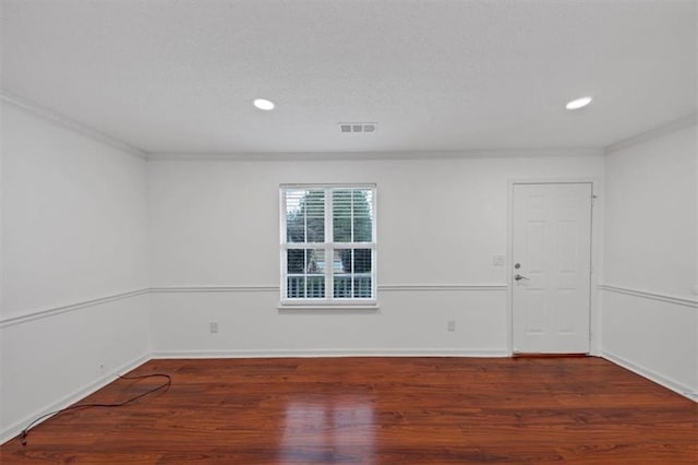 unfurnished room with baseboards, visible vents, ornamental molding, wood finished floors, and recessed lighting