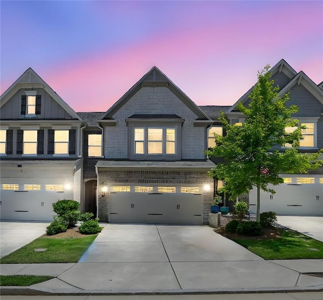 1969 Lanier Harbor Pt, Buford, GA 30518 - view of front of house featuring driveway, brick siding, and an attached garage