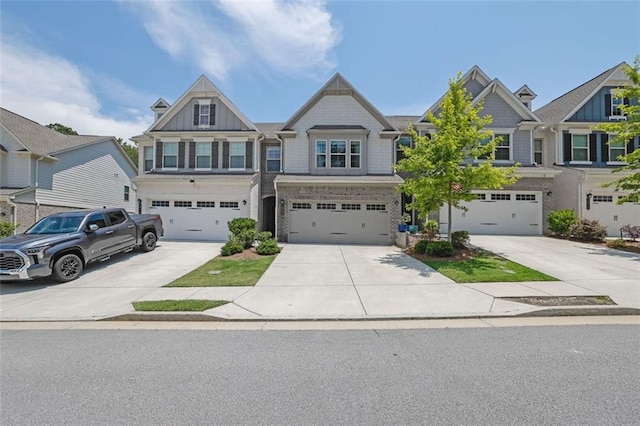 1969 Lanier Harbor Pt, Buford, GA 30518 - view of front of house featuring concrete driveway, a garage, and board and batten siding