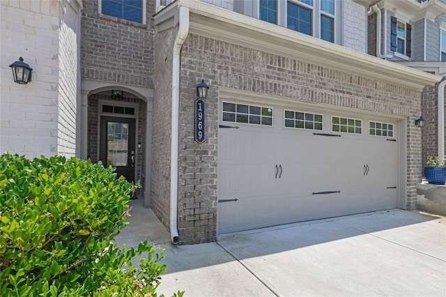 1969 Lanier Harbor Pt, Buford, GA 30518 - entrance to property featuring an attached garage, driveway, and brick siding