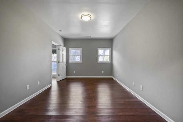 unfurnished room with dark hardwood / wood-style floors