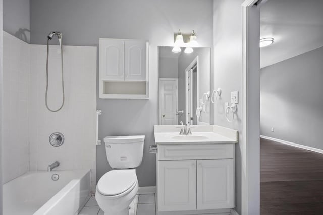 full bathroom featuring tiled shower / bath, vanity, tile patterned floors, and toilet