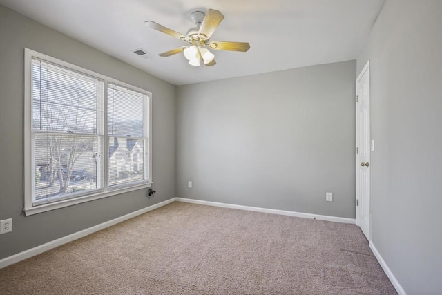 carpeted spare room with ceiling fan