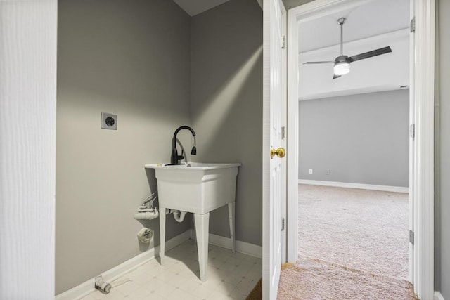 laundry area featuring electric dryer hookup, light colored carpet, and ceiling fan