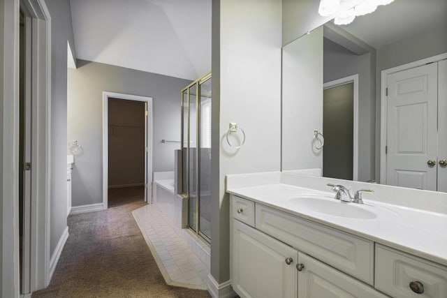 bathroom with vanity, independent shower and bath, and vaulted ceiling