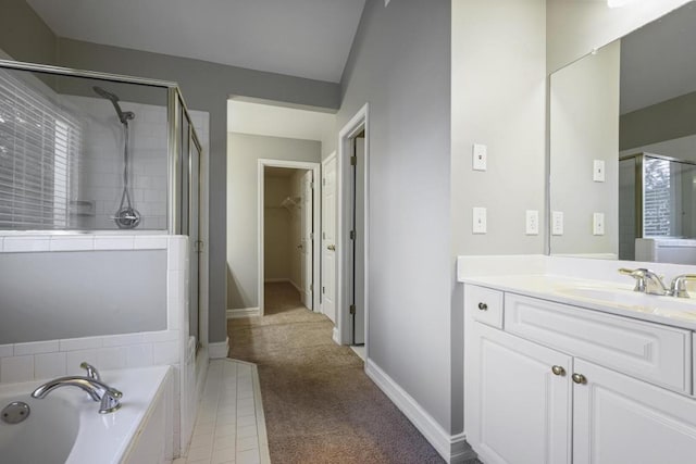 bathroom featuring vanity and independent shower and bath