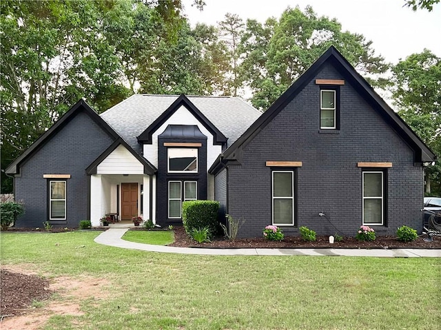 view of front of house with brick siding and a front yard