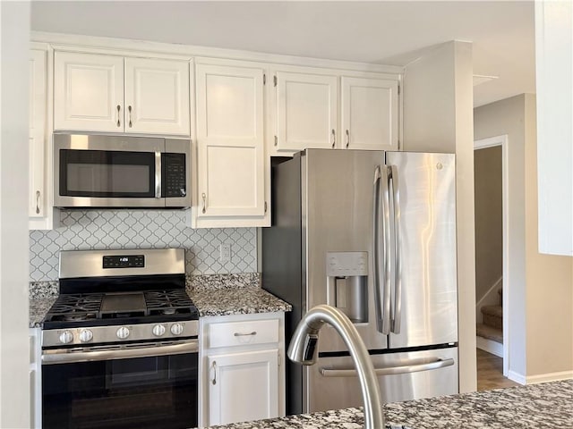 kitchen featuring stainless steel appliances and white cabinetry