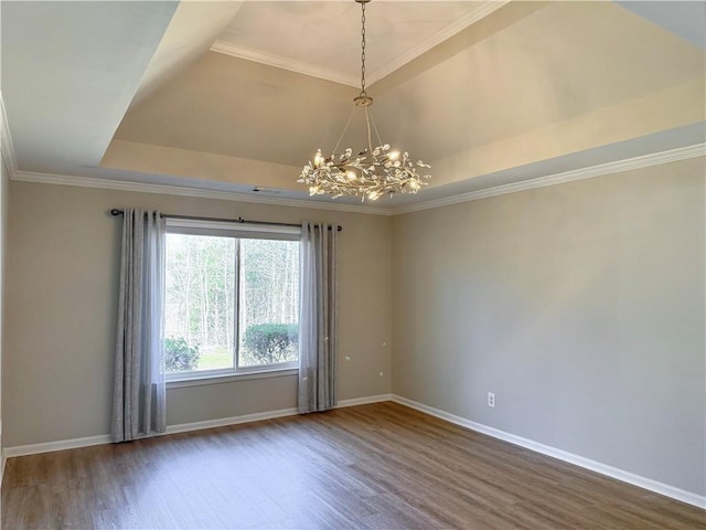 empty room with a raised ceiling, baseboards, a notable chandelier, and dark wood-style flooring