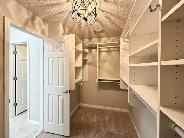 walk in closet with carpet floors and visible vents