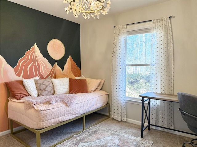 living area featuring baseboards, carpet, and an inviting chandelier