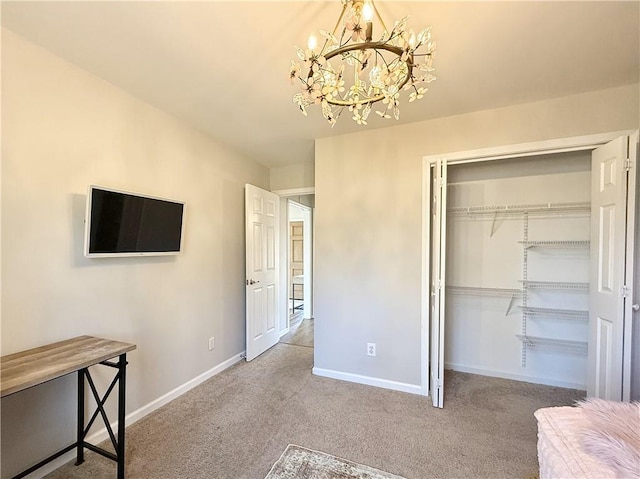 unfurnished bedroom with light carpet, a notable chandelier, baseboards, and a closet