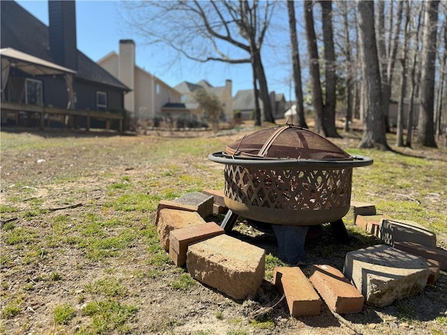 view of yard featuring an outdoor fire pit