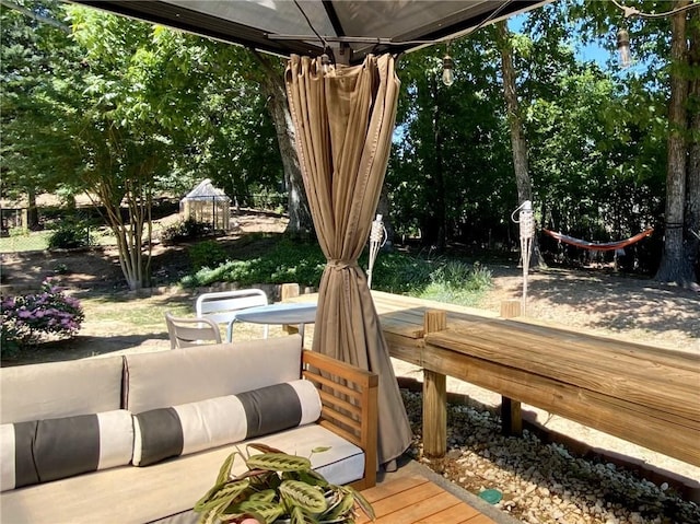 wooden terrace featuring outdoor dining area