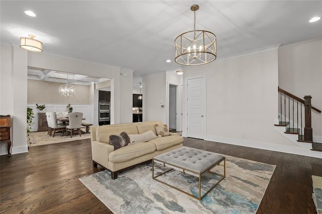 living room featuring coffered ceiling, ornamental molding, dark hardwood / wood-style flooring, a notable chandelier, and beam ceiling