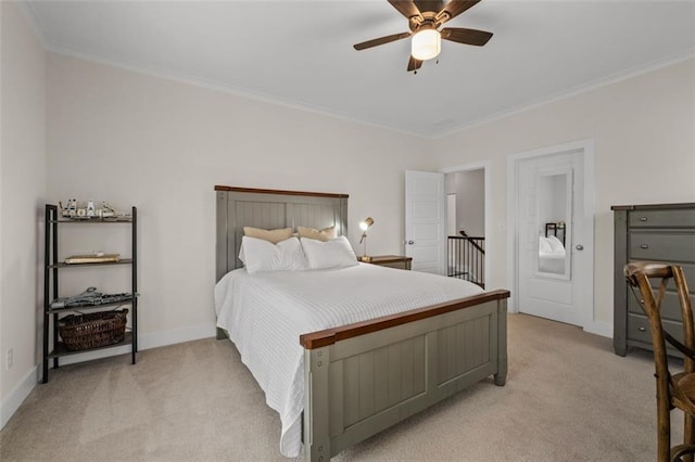 carpeted bedroom with crown molding and ceiling fan