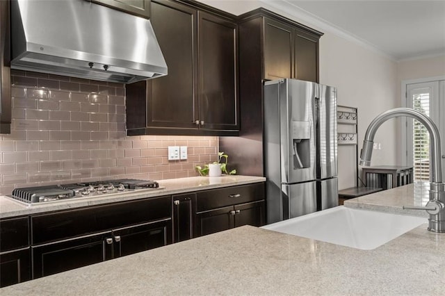 kitchen with sink, crown molding, appliances with stainless steel finishes, dark brown cabinets, and tasteful backsplash