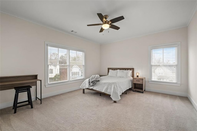 carpeted bedroom featuring crown molding and ceiling fan