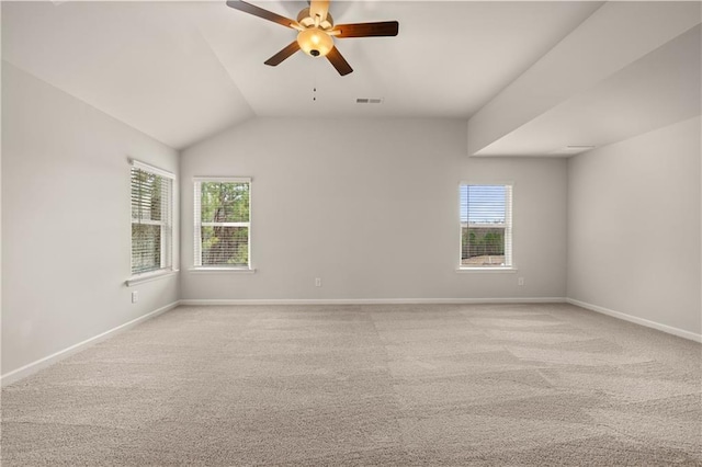 unfurnished room featuring light carpet, ceiling fan, plenty of natural light, and baseboards