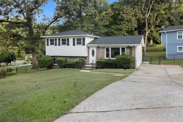 tri-level home with a front yard