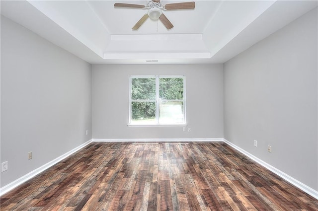4041 Ash Tree St, Snellville, GA 30039 - empty room featuring a tray ceiling, ceiling fan, dark wood-style floors, and baseboards