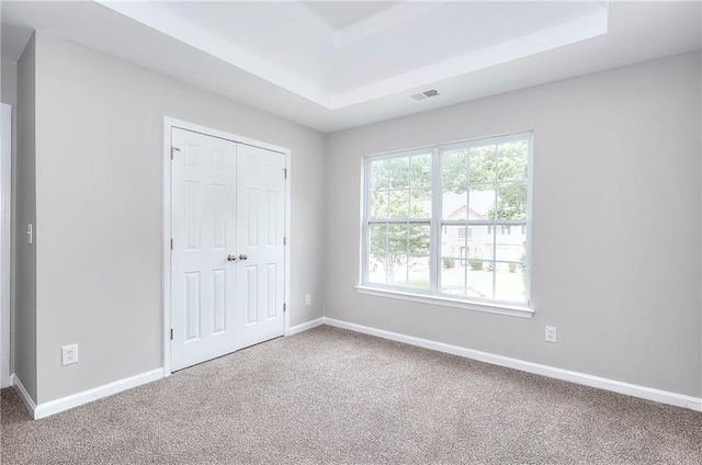 4041 Ash Tree St, Snellville, GA 30039 - unfurnished bedroom with carpet flooring, a tray ceiling, baseboards, and a closet