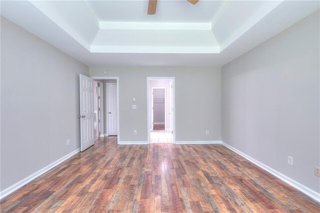 4041 Ash Tree St, Snellville, GA 30039 - unfurnished bedroom with a raised ceiling, wood finished floors, baseboards, and a ceiling fan