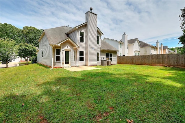 4041 Ash Tree St, Snellville, GA 30039 - rear view of property featuring a patio, a chimney, and central AC unit